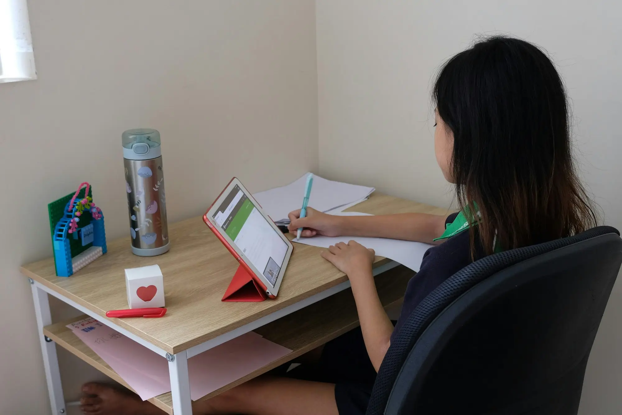 Woman working through paperwork at her desk