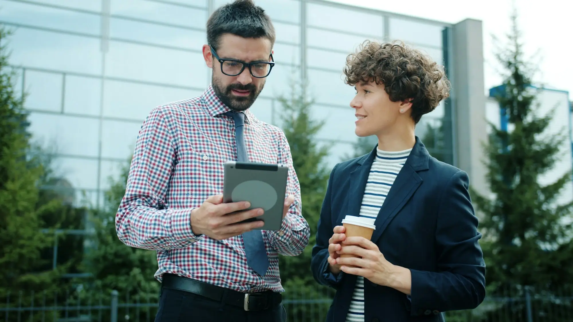 Two business owners discussing a tablet outdoors