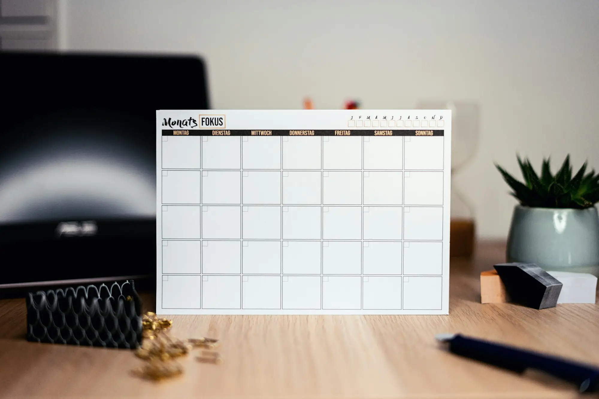 Blank wall calendar on a desk